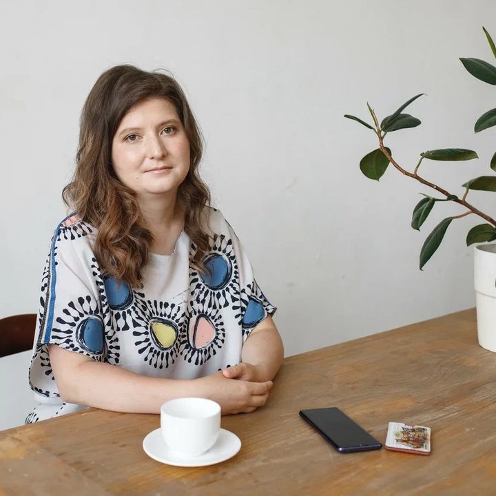 Alexandra Elbakyan, founder of Sci-Hub, sits at a table.