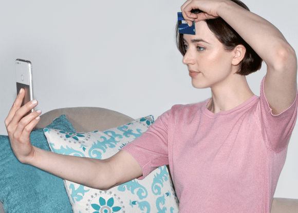 Woman measuring her pupillary distance.