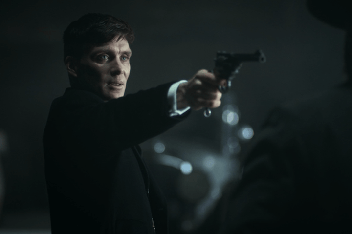 Cillian Murphy holding a gun in Peaky Blinders.