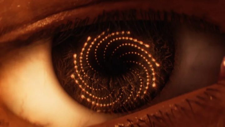 A spiral of bullets reflected in an eye.